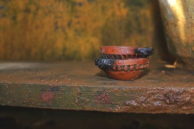 Close-up of rusty metal on table