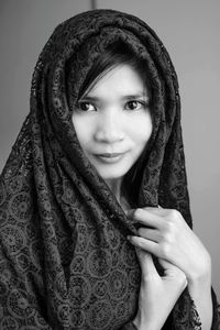 Portrait of young woman wearing scarf at home