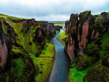 River amidst mountains against sky