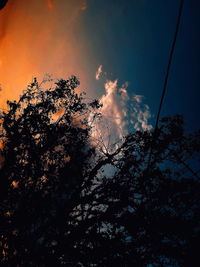 Low angle view of silhouette trees against sky at sunset