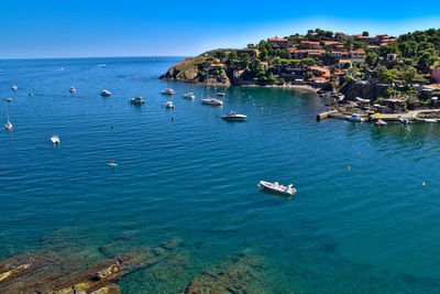 High angle view of sailboats in sea against sky