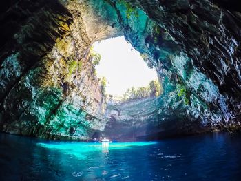 Scenic view of sea seen through cave