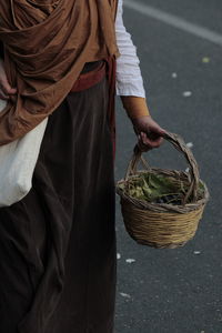 Low section of woman holding plant