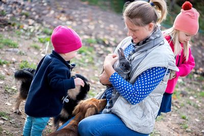 Rear view of women with dogs