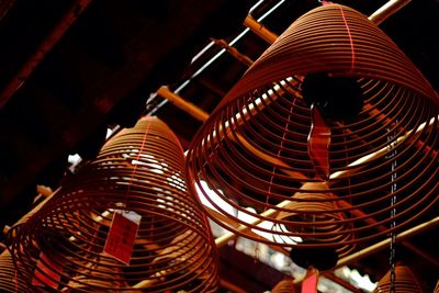 Low angle view of illuminated lanterns hanging from ceiling at night