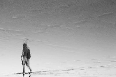 Person walking on sand dune at beach