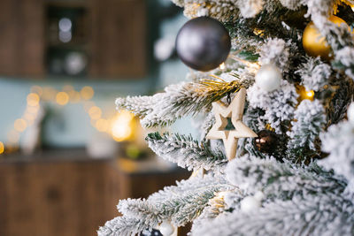 Christmas wooden star toy on christmas tree with copy space