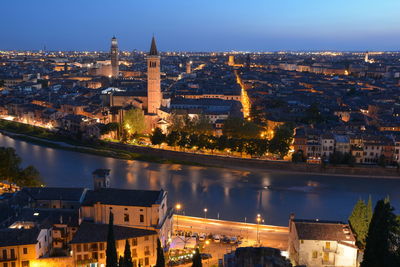 Verona at sunset, high angle view of illuminated buildings in city