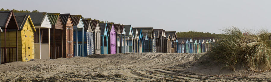 Multi colored umbrellas on beach against clear sky