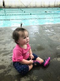 Girl sitting in swimming pool