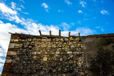 Old house wall made of old stones and wood