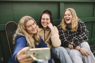 Teenage girls taking selfie with smart phone