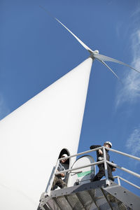 Engineers in front of wind turbine