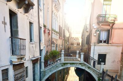 Bridge over canal amidst buildings in town