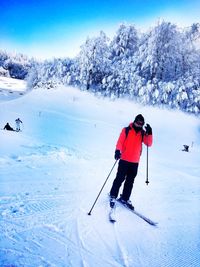 Full length of man skiing on snow covered field