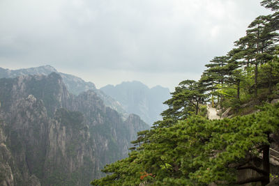 Scenic view of mountains against cloudy sky