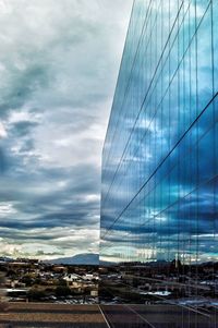 Modern buildings against cloudy sky