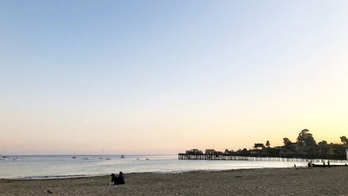 Scenic view of sea against clear sky during sunset