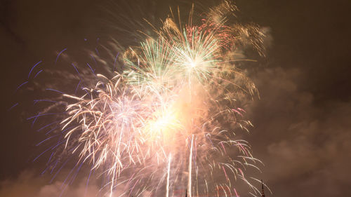 Low angle view of firework display at night