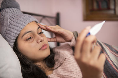 Close-up of young woman using mobile phone