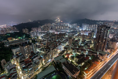 Aerial view of city lit up at night