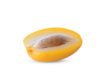 Close-up of orange slice against white background