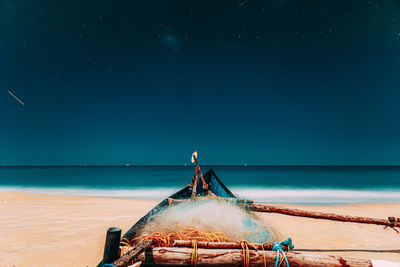 Rear view of people on beach against sky