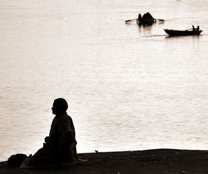 Rear view of man looking at sea