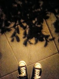 Low section of woman standing on tiled floor