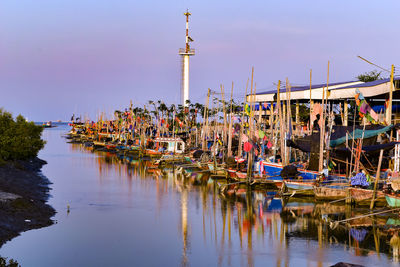 Panoramic view of building by lake against clear sky
