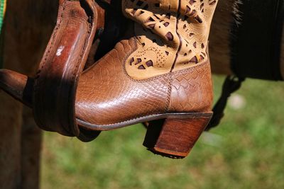 Close-up of shoes hanging on wood