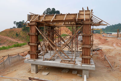 Abandoned construction site on field against sky