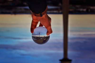 Close-up of reflection of man in water