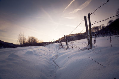 Snow covered landscape against sky