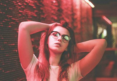 Close-up portrait of woman in city at night