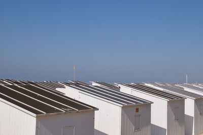 High angle view of beach huts against clear blue sky