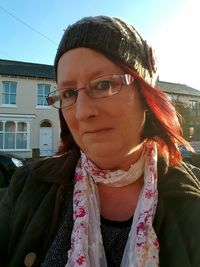 Portrait of young woman wearing sunglasses against sky