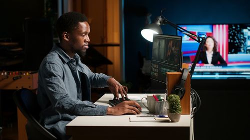Young man using mobile phone while sitting at home