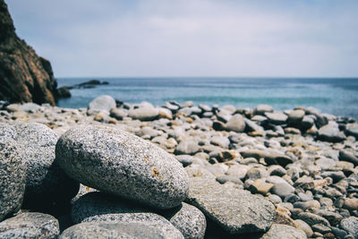 Rocks on beach against sky