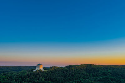 Scenic view of mountains against clear sky at sunset