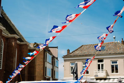 Low angle view of dutch flags on a snack car against sky