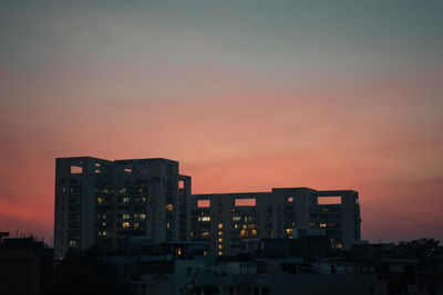 Silhouette buildings against sky during sunset