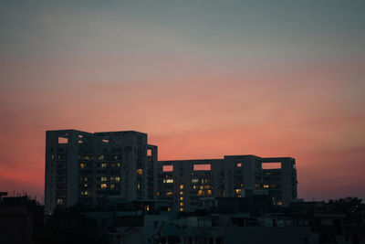 Silhouette buildings against sky during sunset