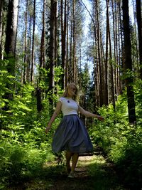 Woman with umbrella in forest