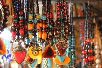 Close-up of colorful necklaces hanging at market