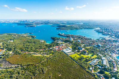 Aerial view of cityscape and sea against sky