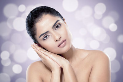 Portrait of beautiful woman against colored background