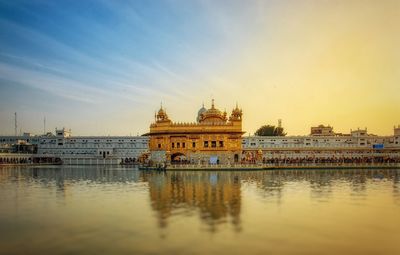 The golden temple in the golden hours reflected in land and sky