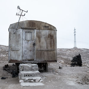 Abandoned built structure on field against clear sky