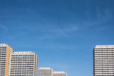 Low angle view of buildings against blue sky